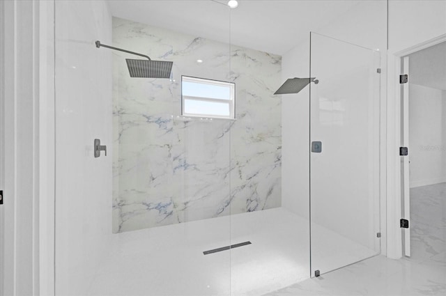 bathroom featuring a marble finish shower and marble finish floors