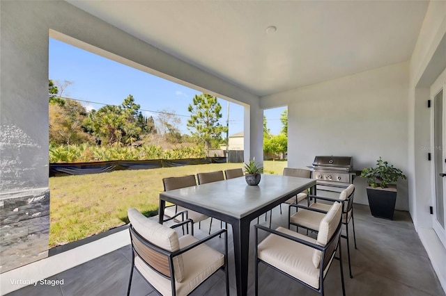 view of patio / terrace featuring outdoor dining area, area for grilling, and exterior kitchen