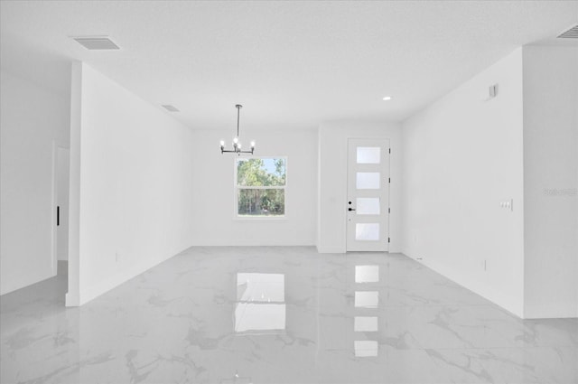 spare room featuring light marble finish floors, a chandelier, baseboards, and recessed lighting