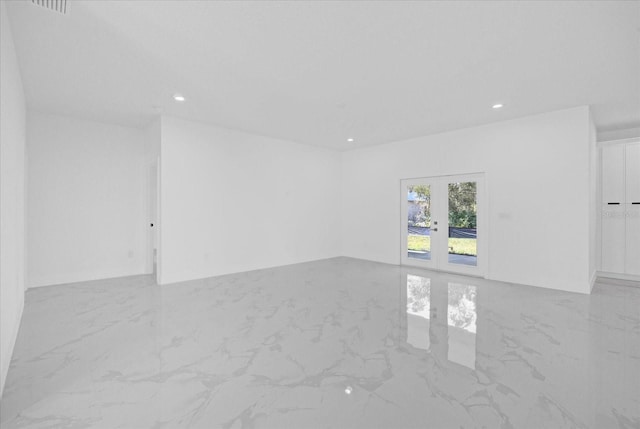 unfurnished room with marble finish floors, french doors, and recessed lighting