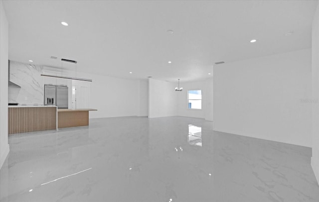spare room with light marble finish floors and recessed lighting