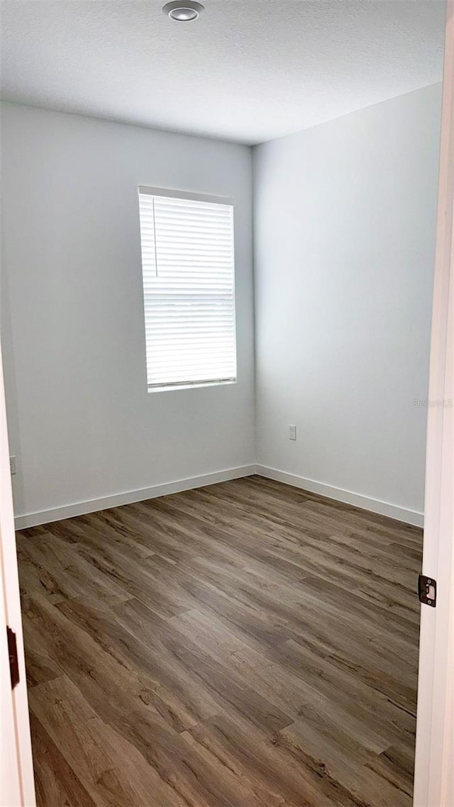 318 Cocoa Ct, Kissimmee, FL 34758 - unfurnished room featuring dark wood-type flooring and baseboards