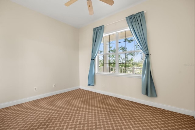 unfurnished room featuring baseboards, ceiling fan, and carpet floors