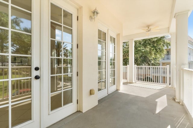 doorway to outside featuring ceiling fan, a wealth of natural light, and concrete flooring
