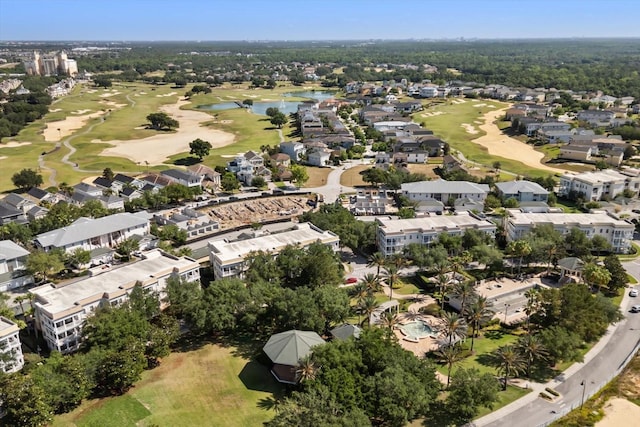 drone / aerial view with a residential view, a water view, and golf course view