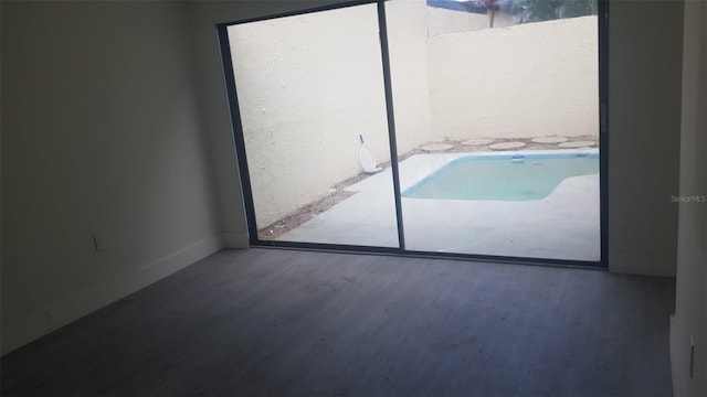 unfurnished bedroom with baseboards and wood finished floors