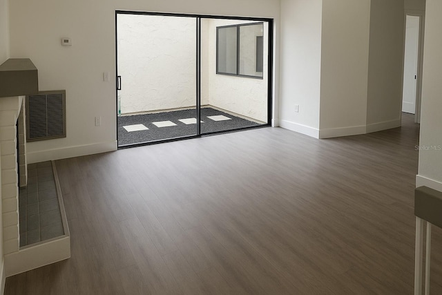 7314 Patio Row, Hudson, FL 34667 - unfurnished living room with wood finished floors and healthy amount of natural light