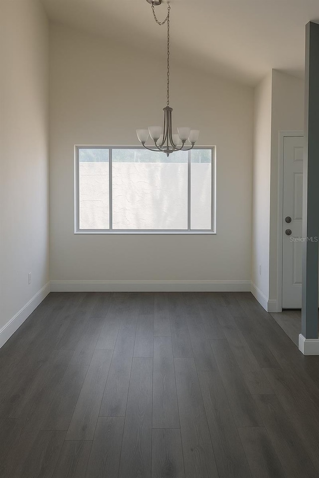 7314 Patio Row, Hudson, FL 34667 - unfurnished dining area with a chandelier, lofted ceiling, and dark wood-style floors