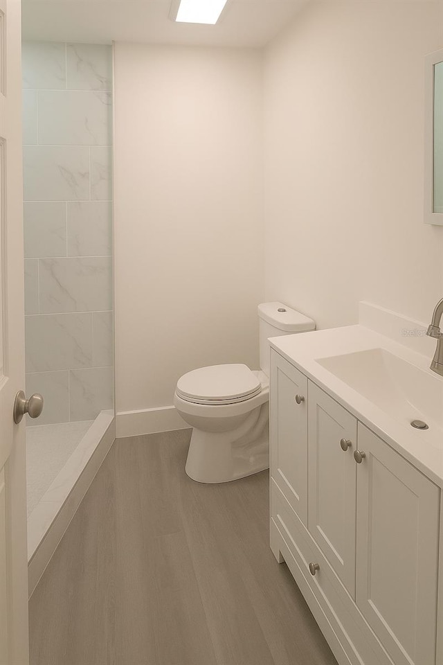 7314 Patio Row, Hudson, FL 34667 - bathroom featuring wood finished floors, vanity, and tiled shower