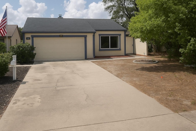 7314 Patio Row, Hudson, FL 34667 - view of front of property featuring a garage, driveway, stucco siding, and roof with shingles