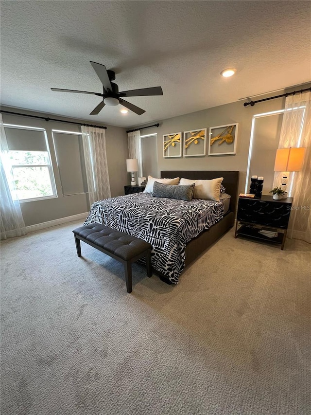 bedroom featuring recessed lighting, a textured ceiling, light carpet, and ceiling fan