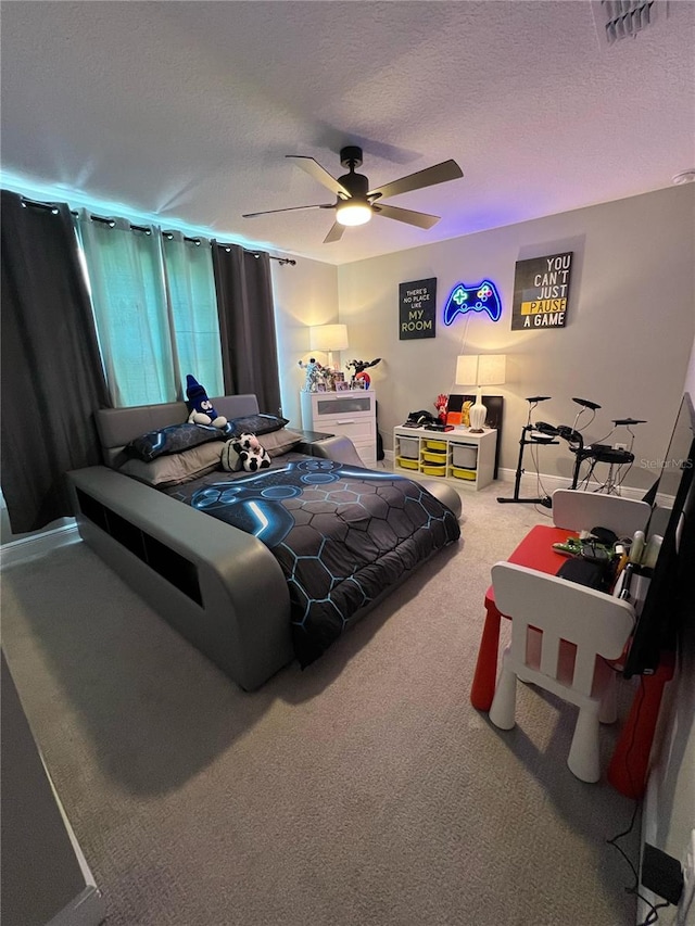 bedroom with carpet floors, a textured ceiling, visible vents, and ceiling fan
