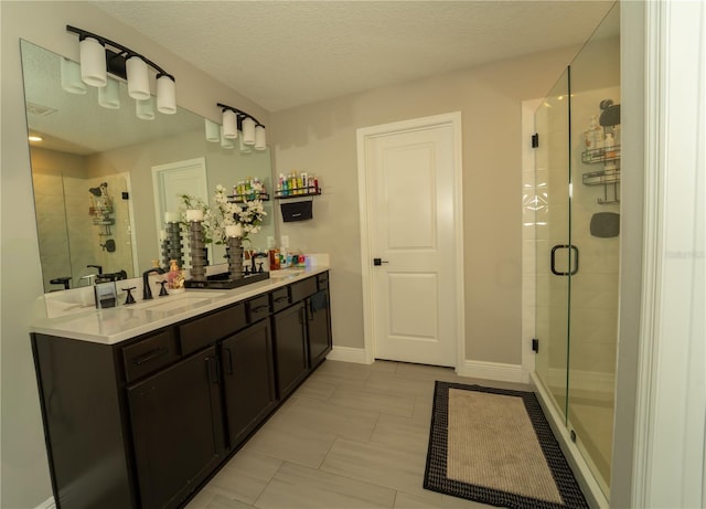 3920 Southern Vista Loop, Saint Cloud, FL 34772 - bathroom with double vanity, a stall shower, and a textured ceiling