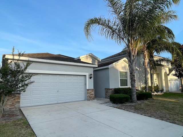 1574 Thetford Cir, Orlando, FL 32824 - single story home with stucco siding, concrete driveway, stone siding, and an attached garage