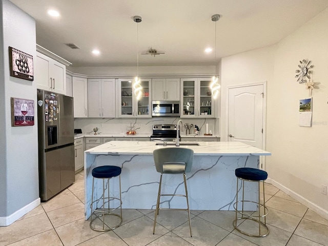 1574 Thetford Cir, Orlando, FL 32824 - kitchen with stainless steel appliances, a sink, a kitchen breakfast bar, light tile patterned flooring, and recessed lighting