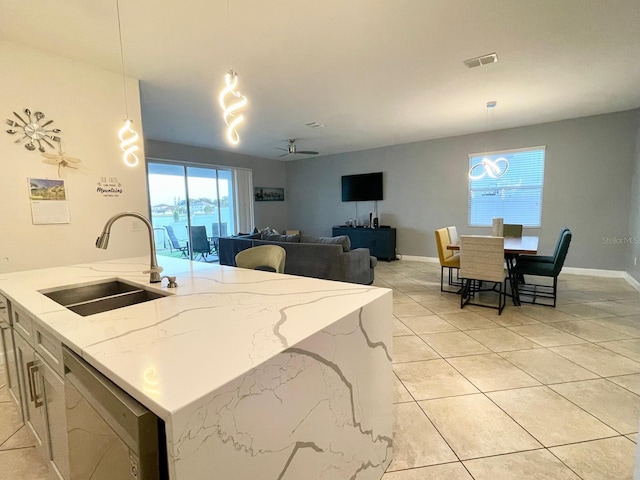 1574 Thetford Cir, Orlando, FL 32824 - kitchen with a sink, dishwasher, hanging light fixtures, light tile patterned flooring, and light stone countertops