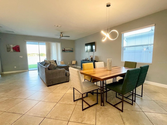1574 Thetford Cir, Orlando, FL 32824 - dining room featuring light tile patterned floors, baseboards, and ceiling fan