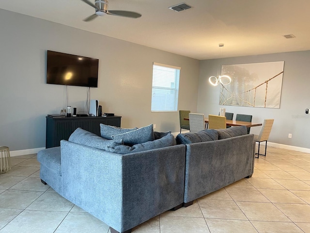 1574 Thetford Cir, Orlando, FL 32824 - living room with light tile patterned flooring, ceiling fan, baseboards, and a chandelier
