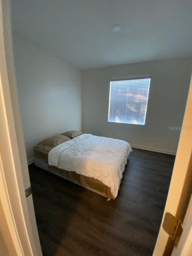 1574 Thetford Cir, Orlando, FL 32824 - bedroom featuring dark wood finished floors and baseboards