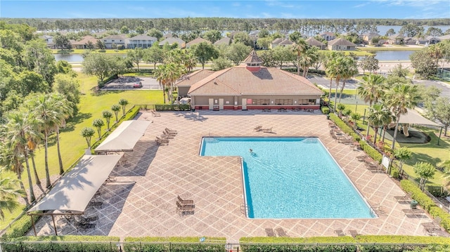 1574 Thetford Cir, Orlando, FL 32824 - view of swimming pool with a water view, a residential view, and a patio area
