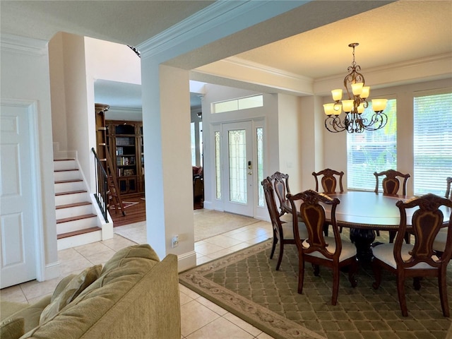 dining space featuring stairs, an inviting chandelier, crown molding, and light tile patterned flooring
