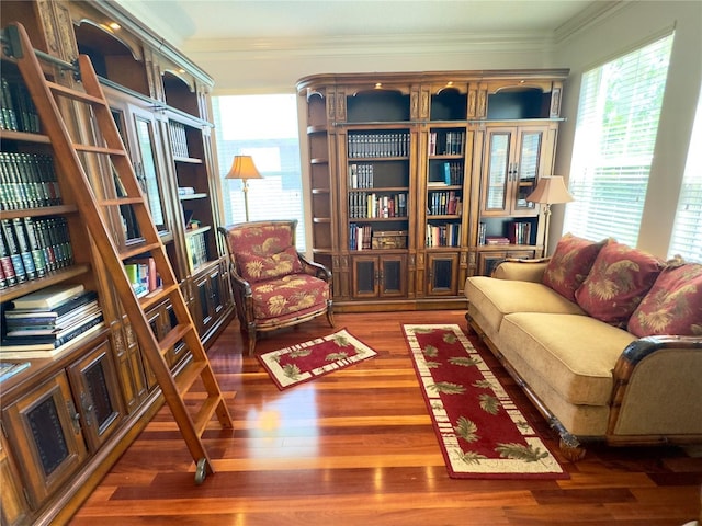 living area with crown molding and wood finished floors