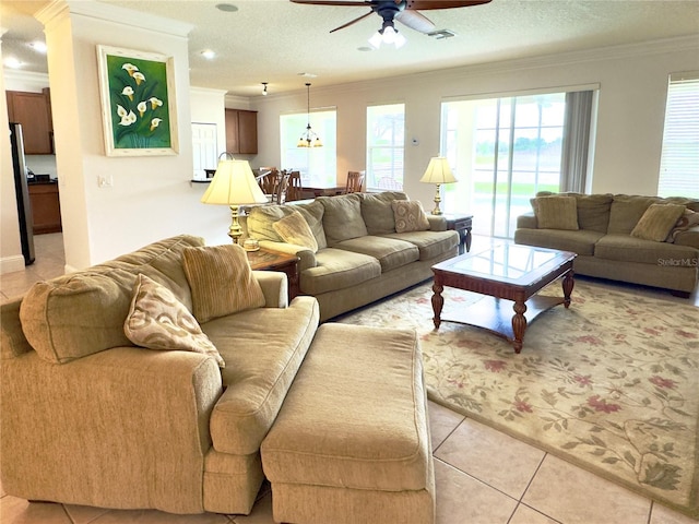 living room with crown molding, light tile patterned floors, and a ceiling fan