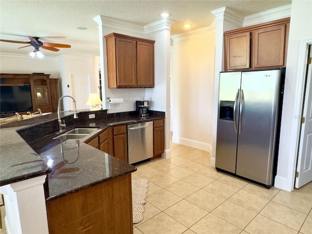 kitchen with light tile patterned floors, a ceiling fan, dark stone countertops, a sink, and stainless steel appliances