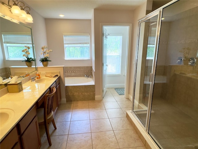 full bathroom with tile patterned floors, a garden tub, a stall shower, and a sink