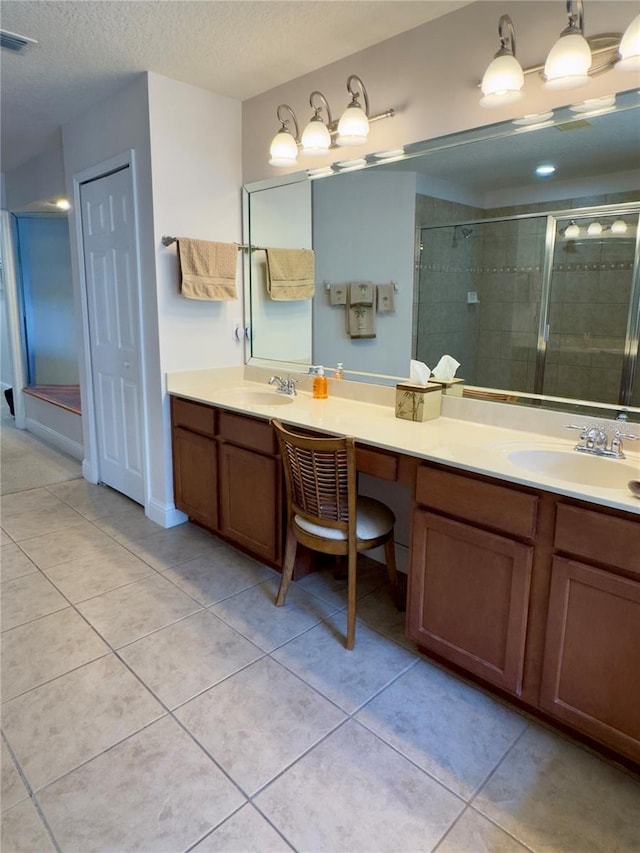 full bathroom with a shower stall, tile patterned flooring, vanity, and visible vents
