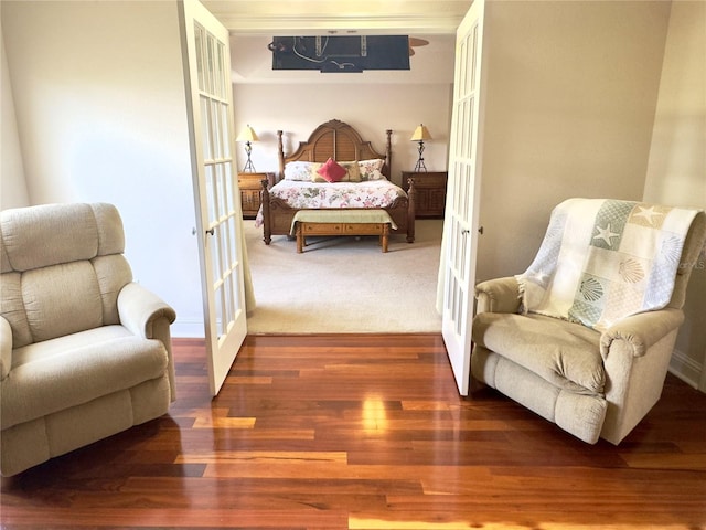 bedroom featuring french doors and wood finished floors