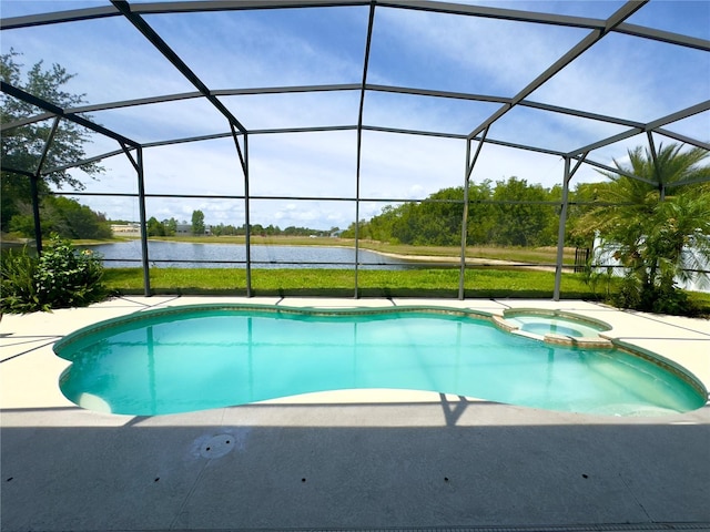 view of pool with a water view, a patio area, glass enclosure, and a pool with connected hot tub