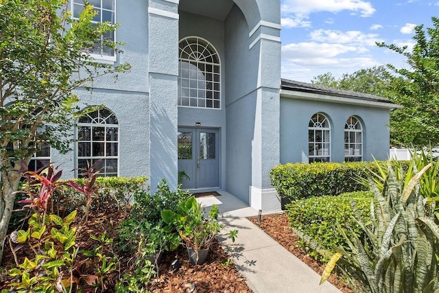 13044 Lakeshore Grove Dr, Winter Garden, FL 34787 - property entrance with stucco siding and french doors