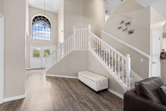 13044 Lakeshore Grove Dr, Winter Garden, FL 34787 - entrance foyer featuring a towering ceiling, wood finished floors, stairs, and baseboards