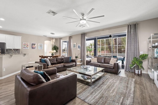 13044 Lakeshore Grove Dr, Winter Garden, FL 34787 - living room featuring ceiling fan, wood finished floors, and baseboards