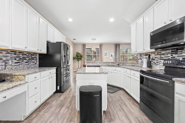13044 Lakeshore Grove Dr, Winter Garden, FL 34787 - kitchen featuring stainless steel appliances, decorative backsplash, white cabinetry, light wood-style flooring, and recessed lighting