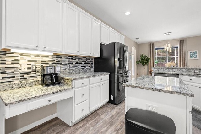 13044 Lakeshore Grove Dr, Winter Garden, FL 34787 - kitchen with fridge with ice dispenser, light wood-style flooring, white cabinets, decorative backsplash, and recessed lighting