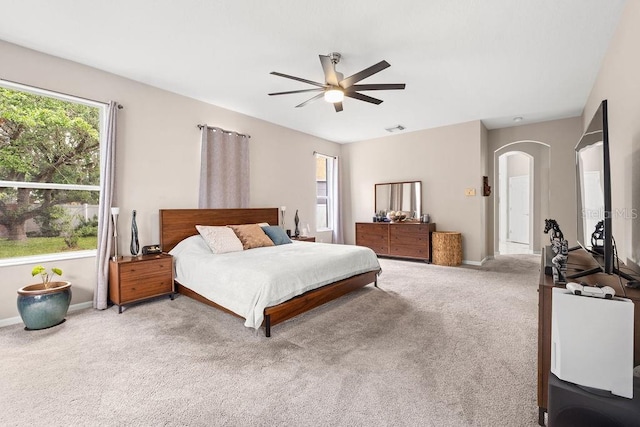 13044 Lakeshore Grove Dr, Winter Garden, FL 34787 - carpeted bedroom with arched walkways, baseboards, and a ceiling fan