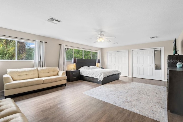 13044 Lakeshore Grove Dr, Winter Garden, FL 34787 - bedroom featuring two closets, wood finished floors, and a ceiling fan