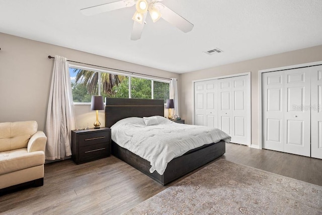 13044 Lakeshore Grove Dr, Winter Garden, FL 34787 - bedroom with multiple closets, wood finished floors, and a ceiling fan