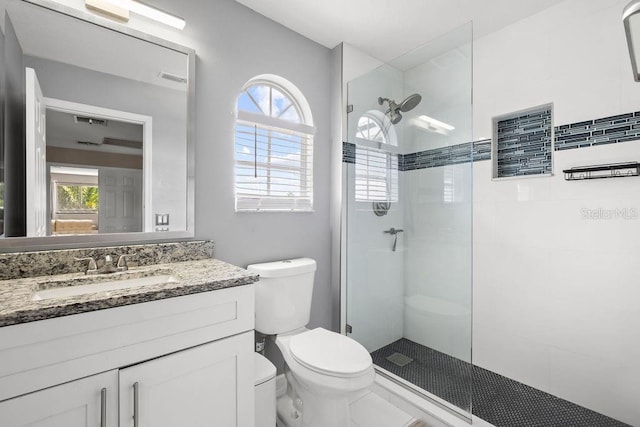 13044 Lakeshore Grove Dr, Winter Garden, FL 34787 - bathroom featuring toilet, a walk in shower, and vanity