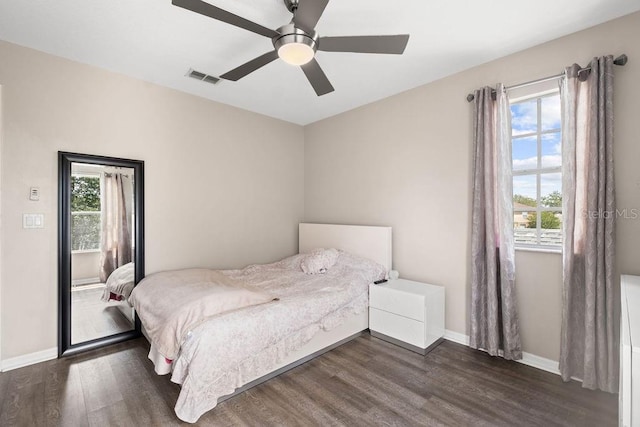 13044 Lakeshore Grove Dr, Winter Garden, FL 34787 - bedroom with dark wood-style flooring, baseboards, and a ceiling fan