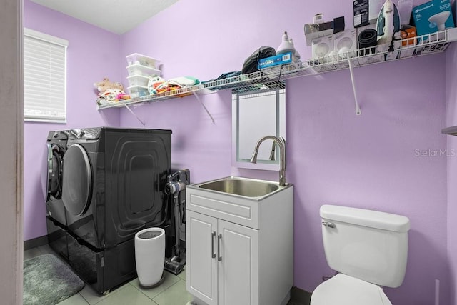 13044 Lakeshore Grove Dr, Winter Garden, FL 34787 - laundry room featuring washer and clothes dryer and light tile patterned floors