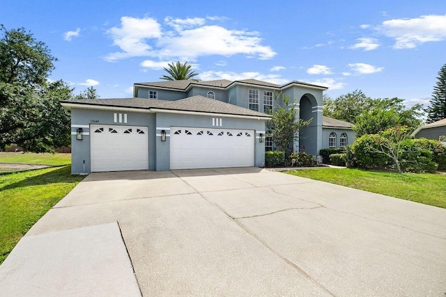 13044 Lakeshore Grove Dr, Winter Garden, FL 34787 - traditional home with stucco siding, an attached garage, driveway, and a front yard