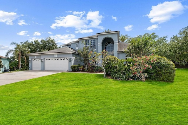 13044 Lakeshore Grove Dr, Winter Garden, FL 34787 - view of front facade featuring driveway, stucco siding, a front yard, and a garage