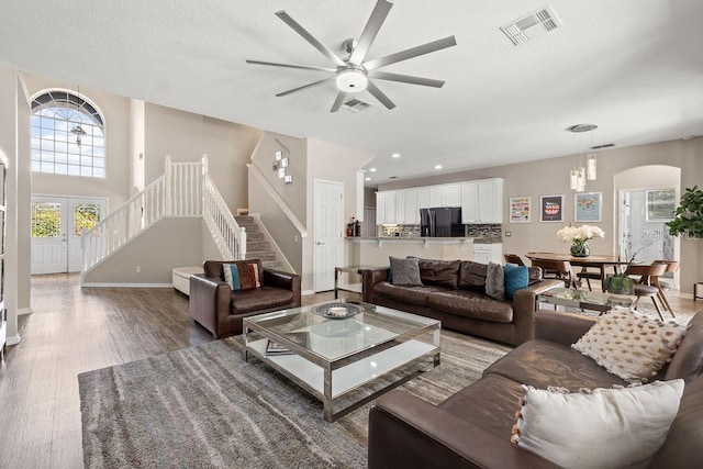 13044 Lakeshore Grove Dr, Winter Garden, FL 34787 - living room with wood finished floors, ceiling fan, stairway, baseboards, and recessed lighting