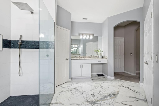 13044 Lakeshore Grove Dr, Winter Garden, FL 34787 - bathroom featuring a walk in shower, vanity, baseboards, and marble tiled flooring