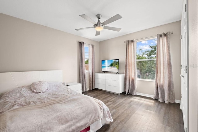 13044 Lakeshore Grove Dr, Winter Garden, FL 34787 - bedroom with wood finished floors, multiple windows, baseboards, and a ceiling fan