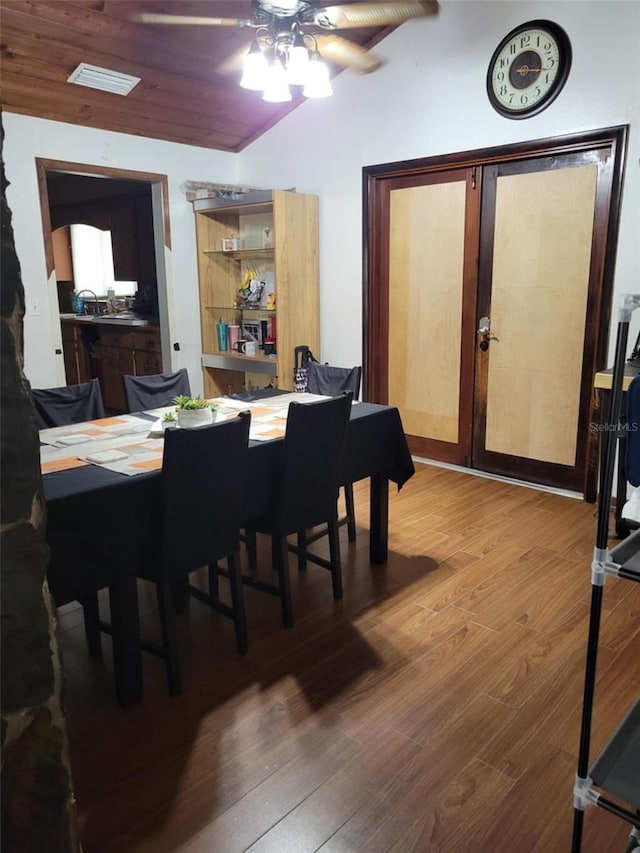 dining room with a ceiling fan, wood finished floors, and visible vents