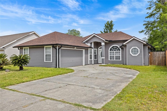 ranch-style home featuring a front lawn, fence, a shingled roof, concrete driveway, and an attached garage